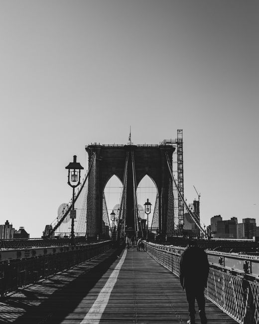 Monochrome view of Brooklyn Bridge, New York City, highlighting its iconic architecture.