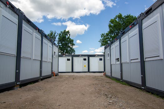 Photo of modern office containers with shutters under a blue sky.