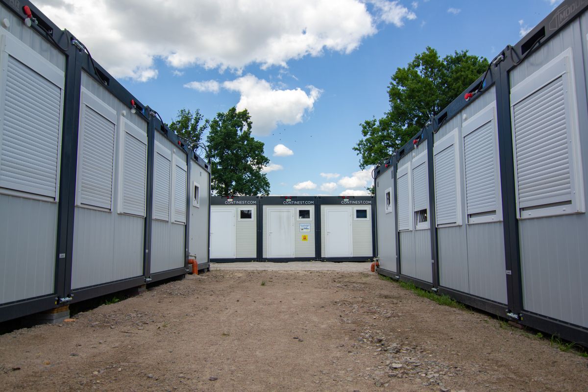 Modern container offices with shutters under a blue sky