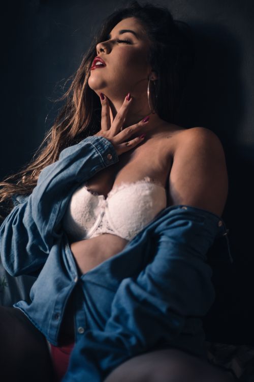 Free Sensual portrait of a woman with eyes closed wearing denim and lingerie. Stock Photo