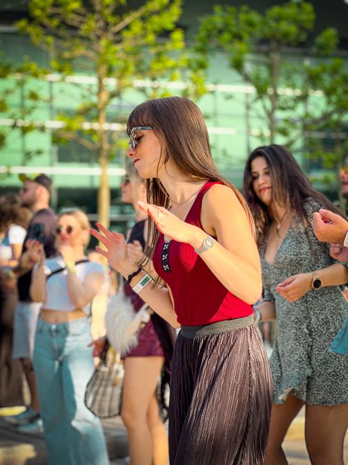 Free Group of young women enjoying a lively dance outdoors during the day. Stock Photo