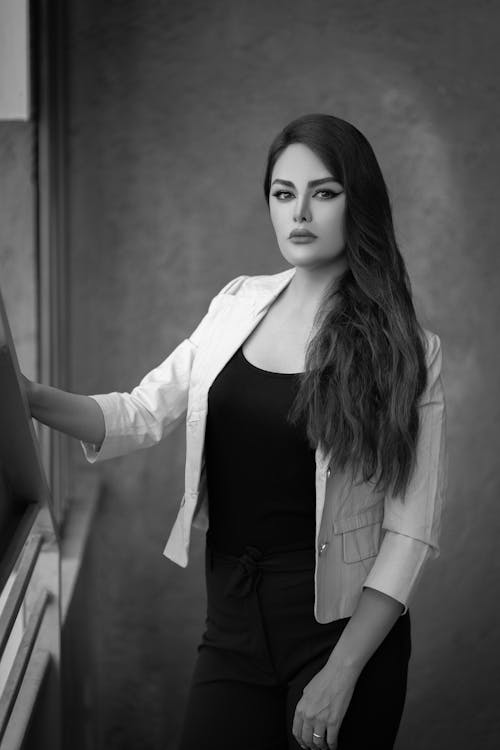 Grayscale Photo of a Woman in White Blazer