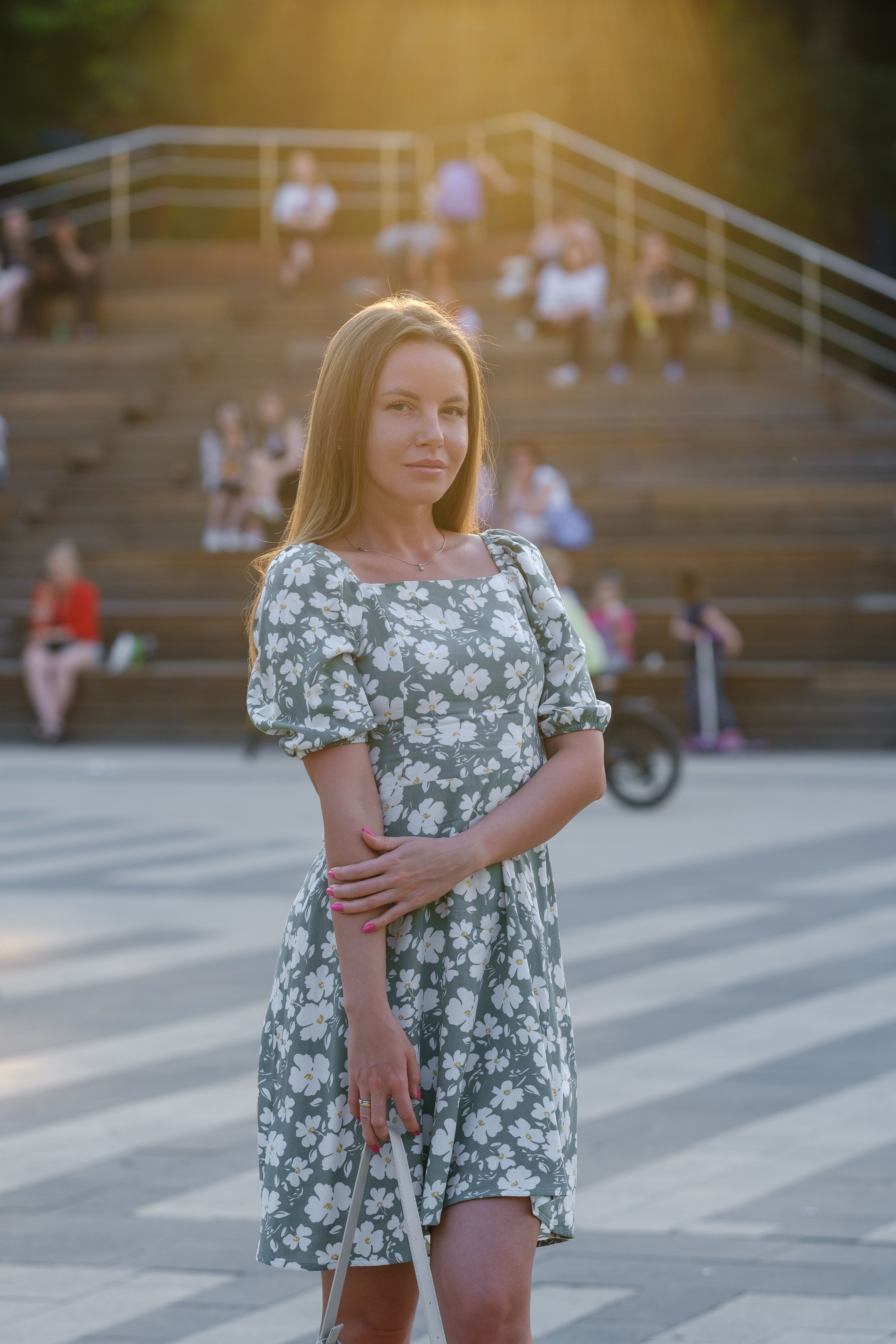 Woman in Floral Dress Standing on a Public Square · Free Stock Photo