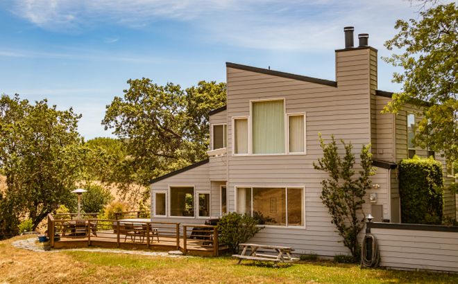 Contemporary house with tall glass windows and a deck — photo by Robert So on Pexels