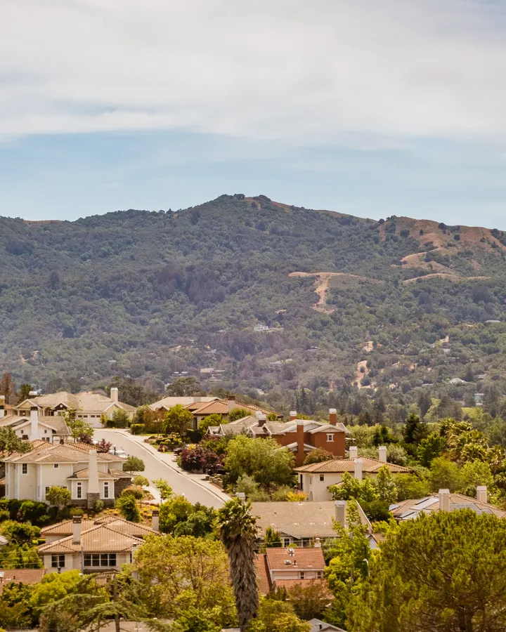 Refrigerator repair in El Cajon, CA Suburban homes set against green hills under a bright sky, the kind of valley neighborhood we serve in El Cajon