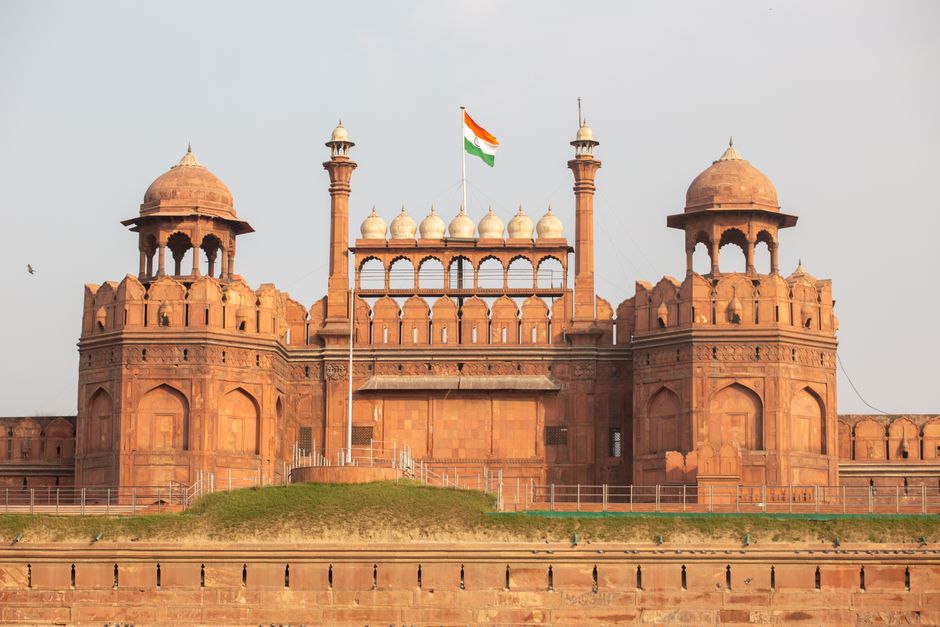The Red Fort in Delhi, India, showcasing its iconic architecture with the national flag flying above.