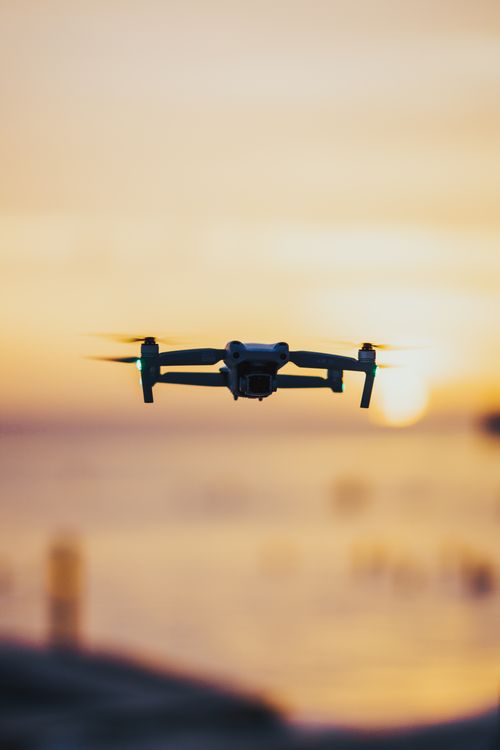 Free Captivating drone hovering over a scenic beach during sunset, highlighting tech and nature. Stock Photo