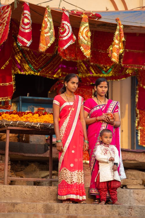Two Women with Boy during Traditional Celebration