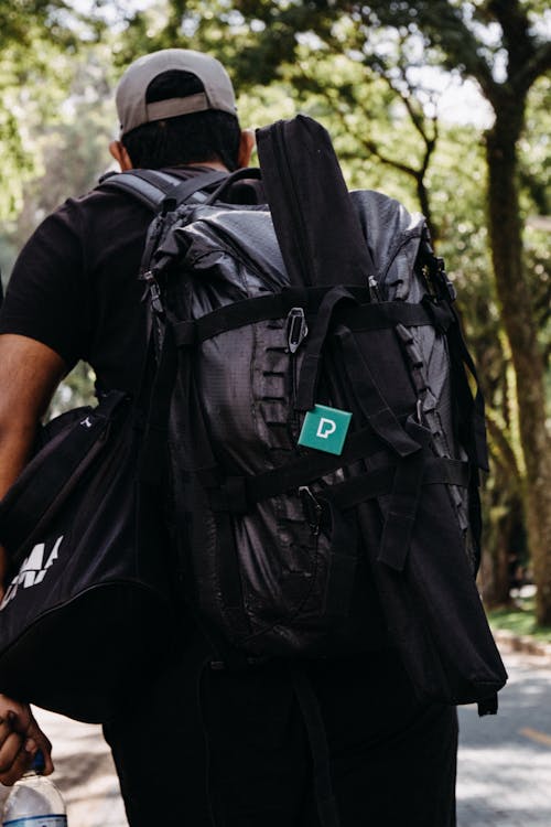 Back View of a Man Hiking with a Backpack 