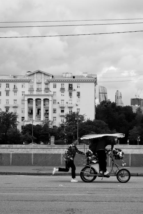 Men Riding Bike on City Road