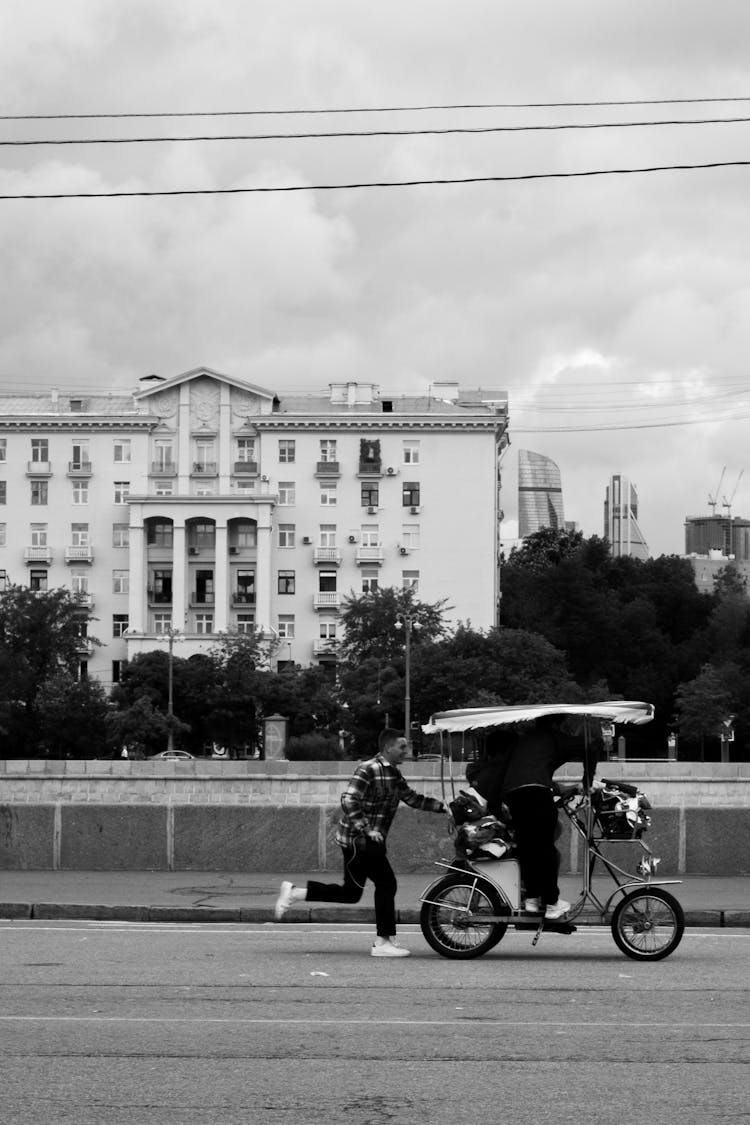 Men Riding Bike On City Road