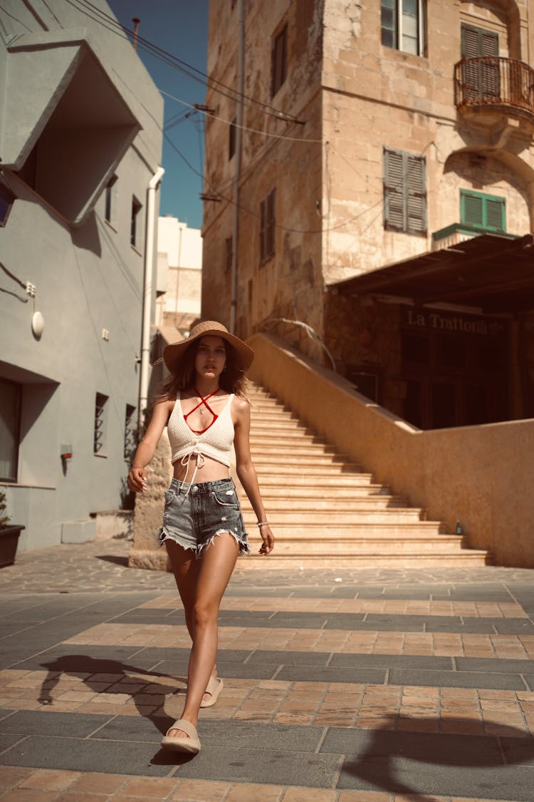 Girl In Hat Walking In Old Town