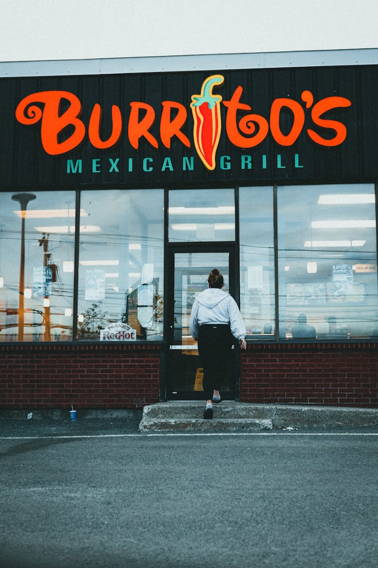 Woman Entering A Restaurant