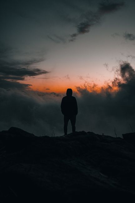 Silhouette of a person standing on a hilltop at twilight in Primorsky Krai, Russia.
