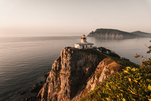 Seacoast with a Lighthouse at Sunset