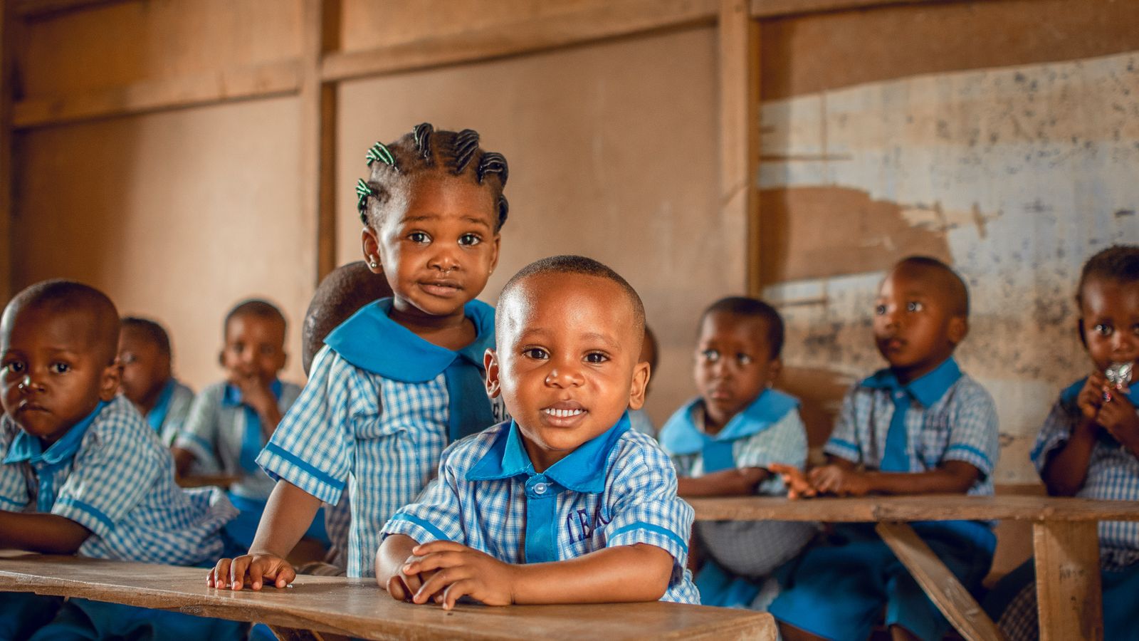 Happy children in a Nigerian classroom wearing uniforms