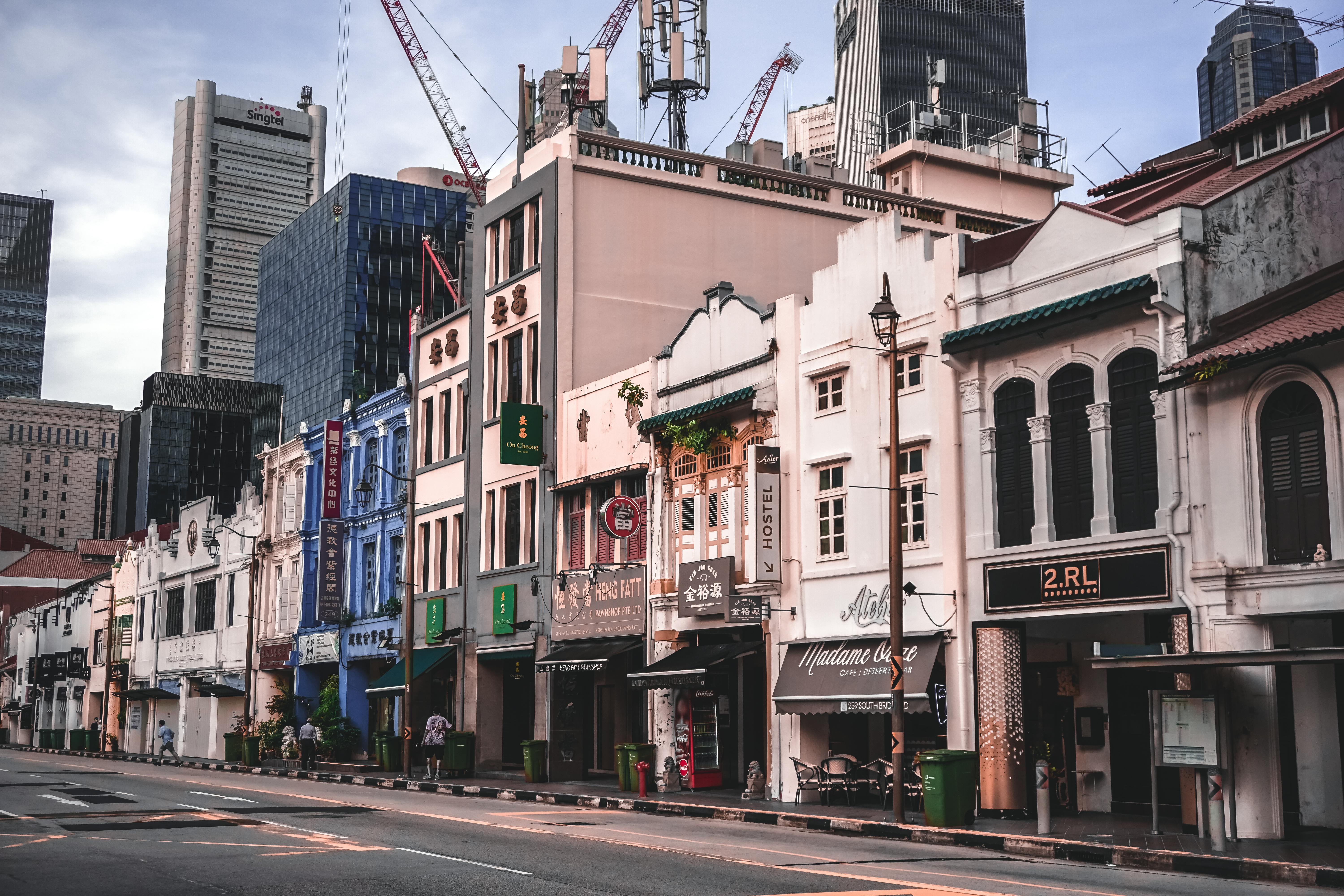 abaya shop singapore - Vibrant shophouses in Singapore's Chinatown amidst modern skyscrapers, showcasing unique architecture.