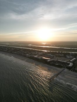 A captivating aerial view of Isle of Palms, SC during a stunning sunset over the coastline.
