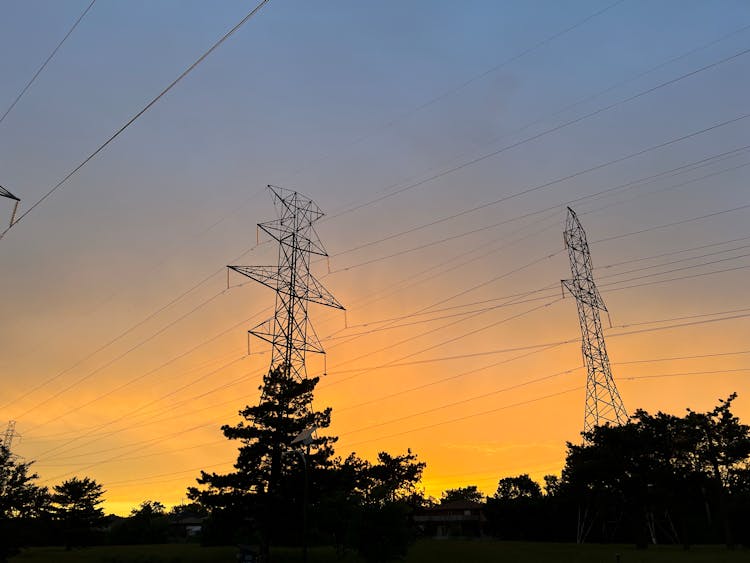 Silhouette Of Electric Towers During Sunset