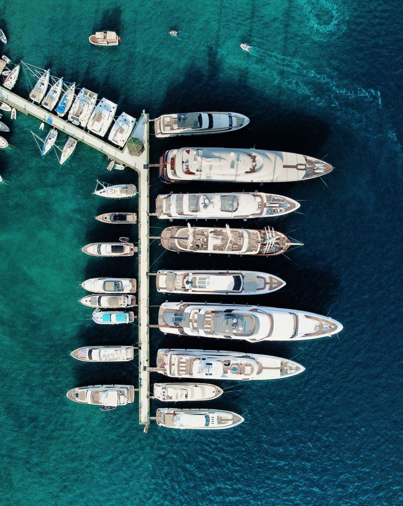 Top view of yachts moored at a marina with turquoise water