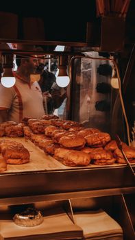 Fresh pastries on display in an Istanbul bakery with ambient lighting, showcasing a bustling atmosphere.