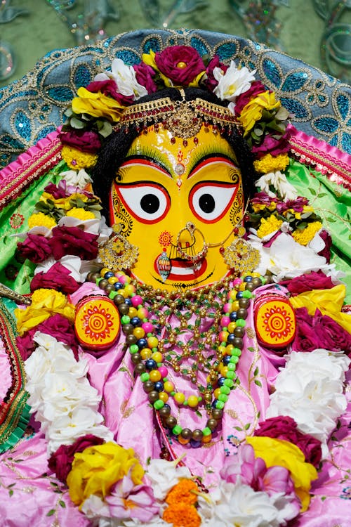 Free Sculpture of deity Jagannath Subhadra Decorated with Flowers and Bead Necklaces Stock Photo