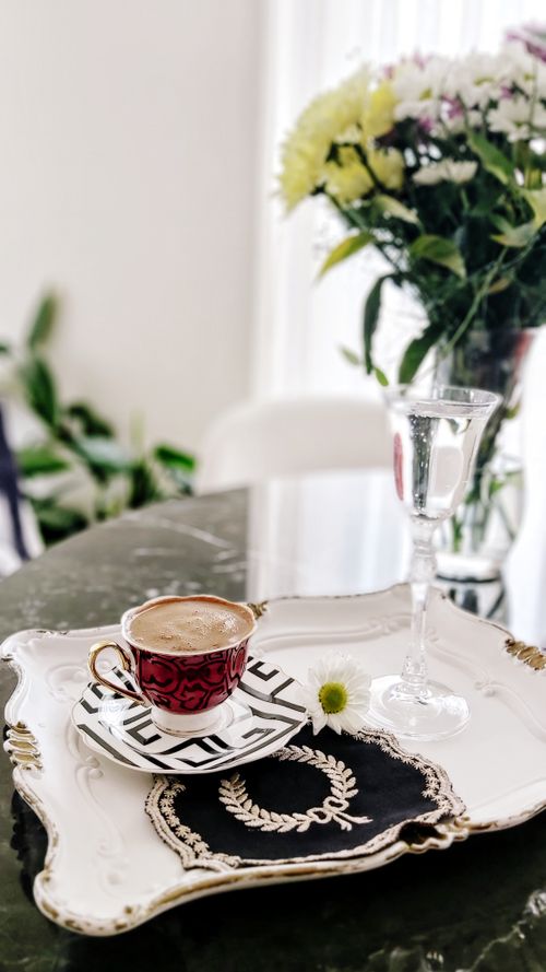 Free Stylish coffee cup on a decorative tray with flowers, perfect for morning vibes. Stock Photo