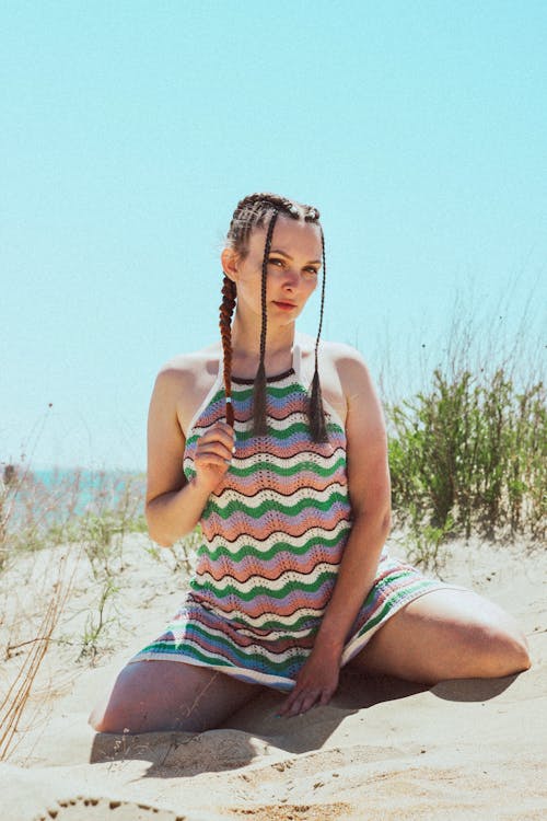 Free Woman Kneeling on Beach Sand Stock Photo