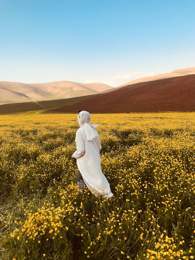Woman In A Field Of Yellow Flowers