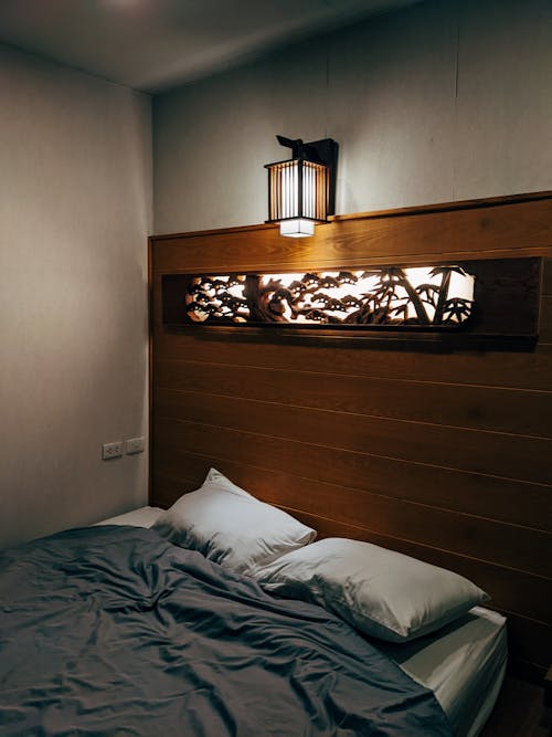 Free Wall Lamp on Top of a Bed  Stock Photo