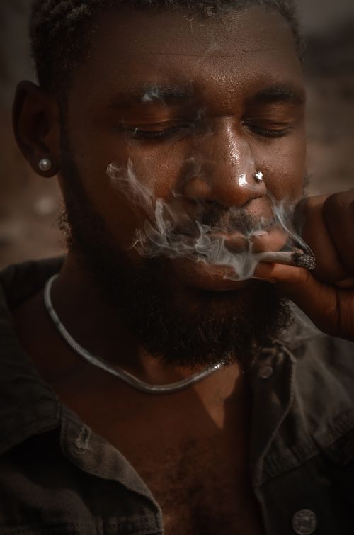 Free A close-up portrait of a man smoking in Abuja, Nigeria. Stock Photo