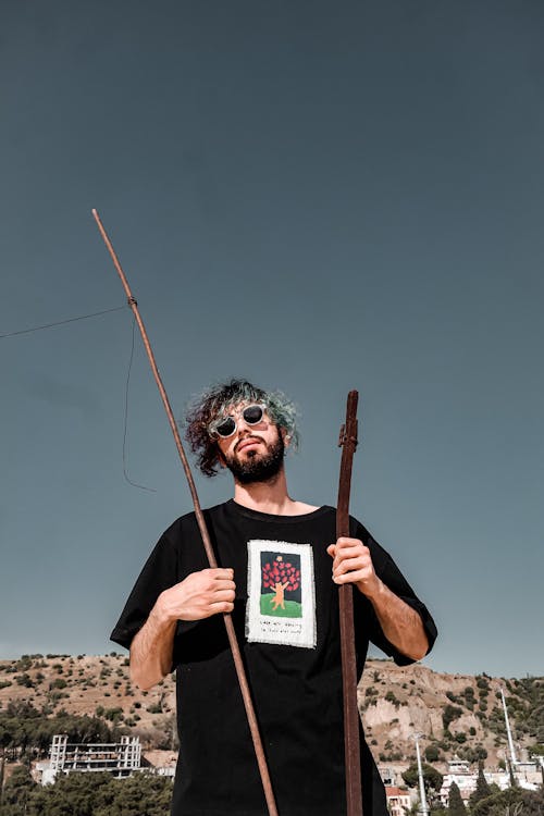 Portrait of Man with Sticks and Curly Hair