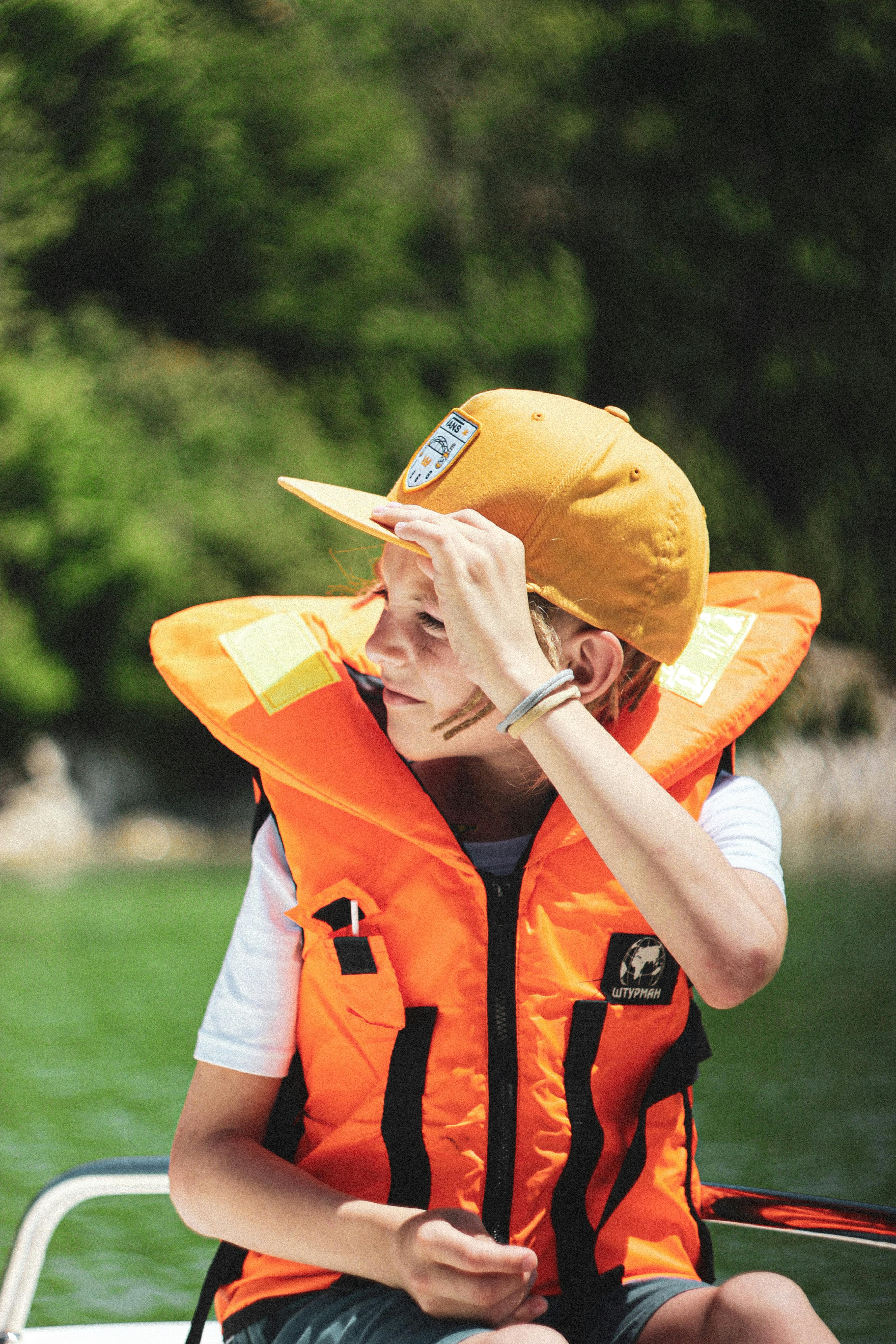 Child wearing life jacket on boat