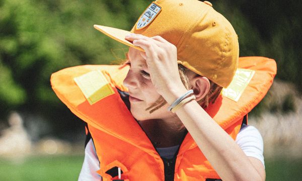 Child wearing life jacket on boat