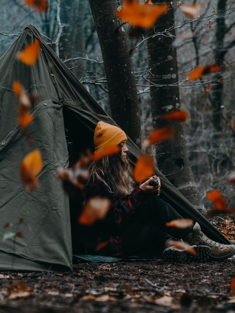 A Woman Sitting On The Tent