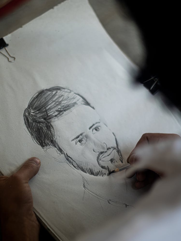 A Person Drawing On A Paper