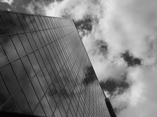 Free Black and white photo of a Toronto skyscraper with clouds reflecting on its glass facade. Stock Photo
