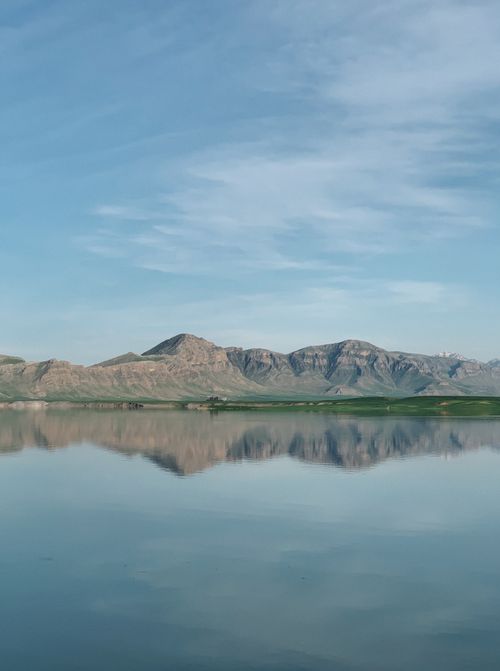 Free Peaceful Ranya landscape capturing mountains mirrored on a tranquil lake. Stock Photo