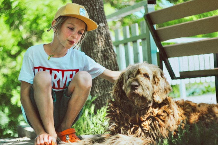 A Girl Petting A Dog