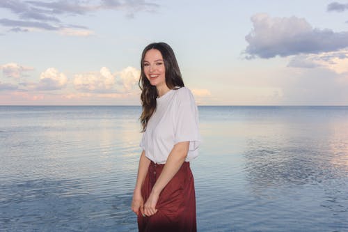 Woman in White Shirt Standing Near Body of Water 
