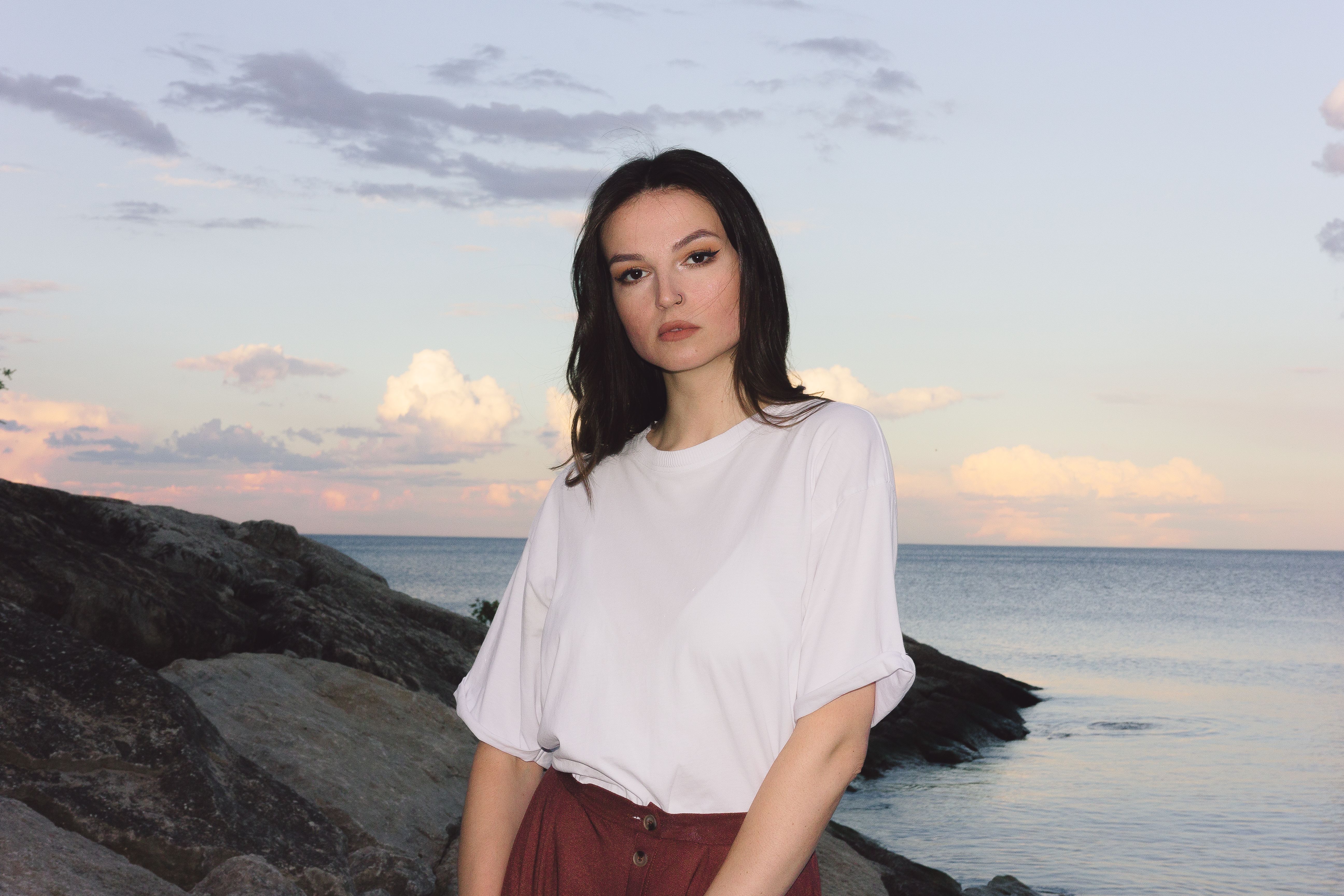 Beautiful Brunette Posing on Beach on Sunset · Free Stock Photo