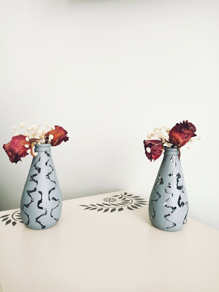 Wilting Red Roses In Vases