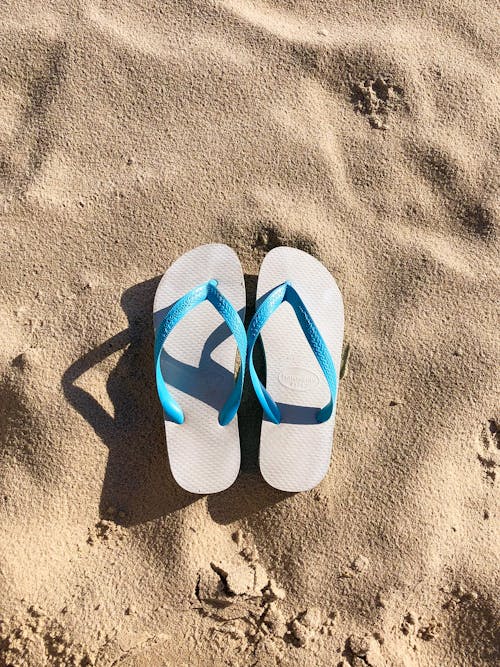 A Pair of Flip Flops on the Sand 