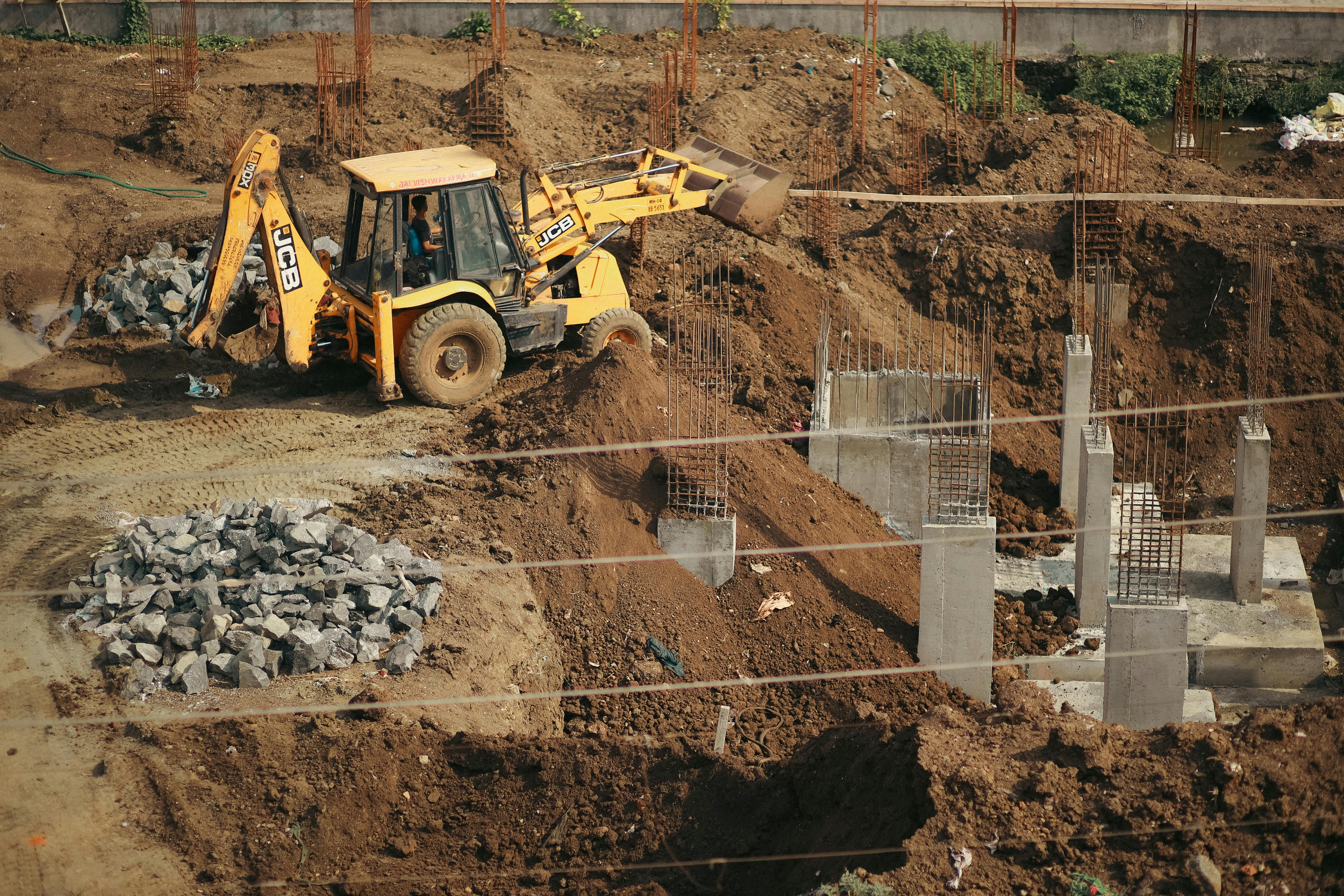 yellow and black heavy equipment on brown sand