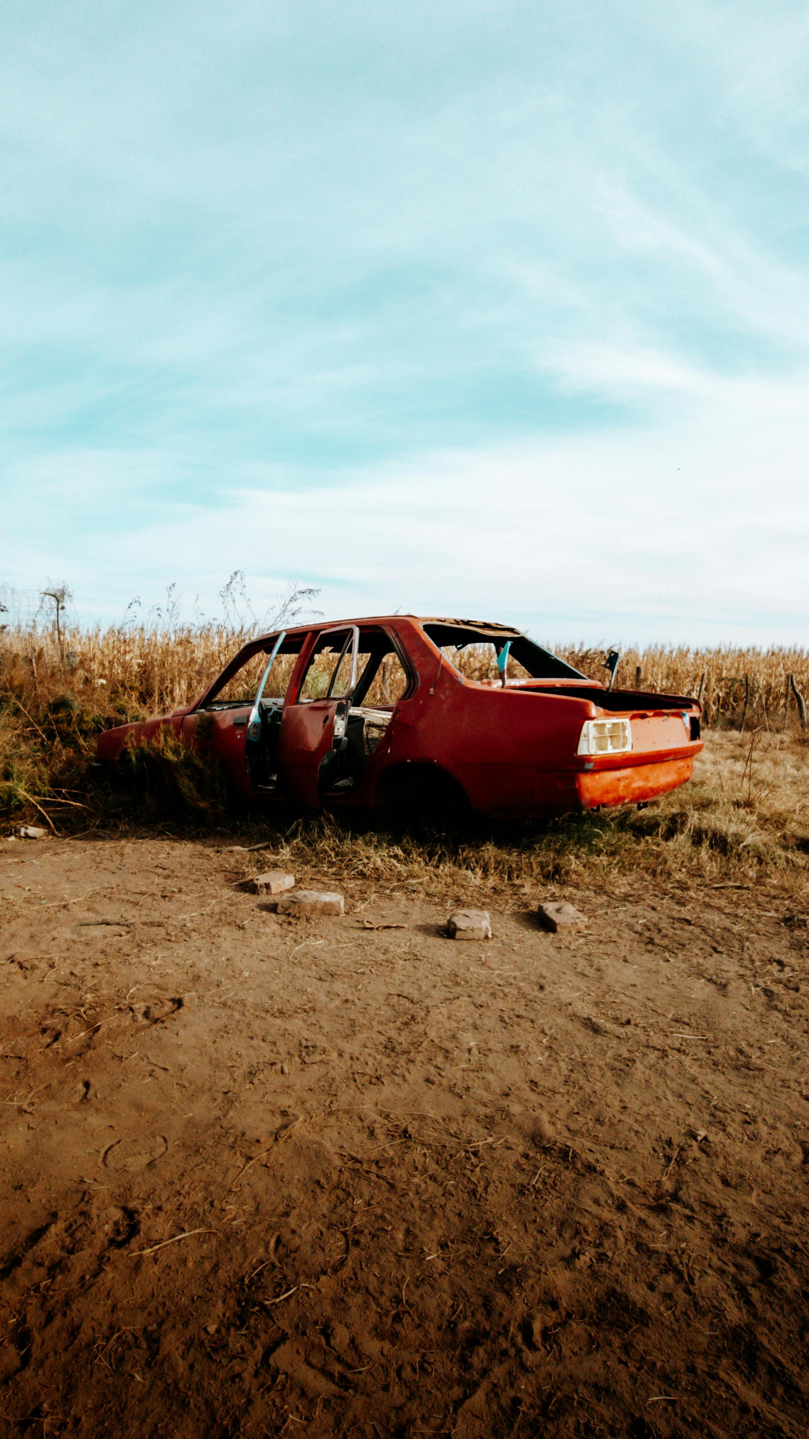 Man Repairing Red Car by the Sea · Free Stock Photo