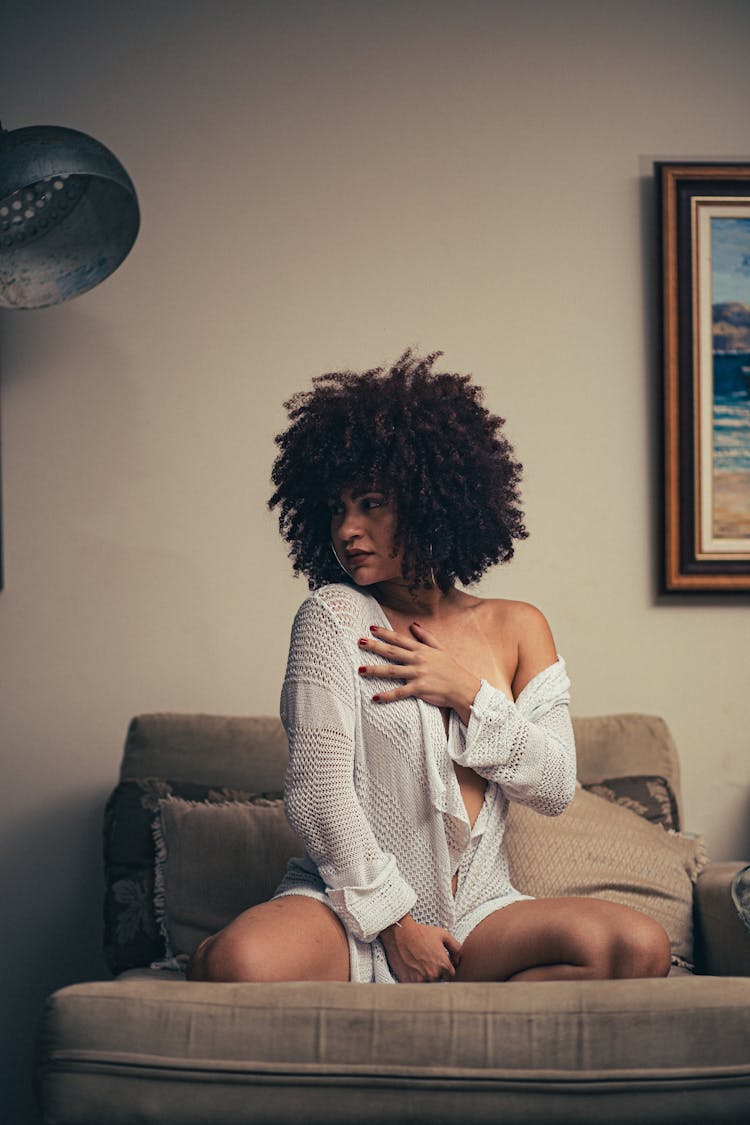 Woman In White Long Sleeve Dress Sitting On Sofa 