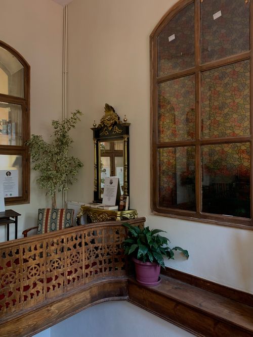 Free A cozy vintage interior featuring stained glass and classic furnishings. Stock Photo