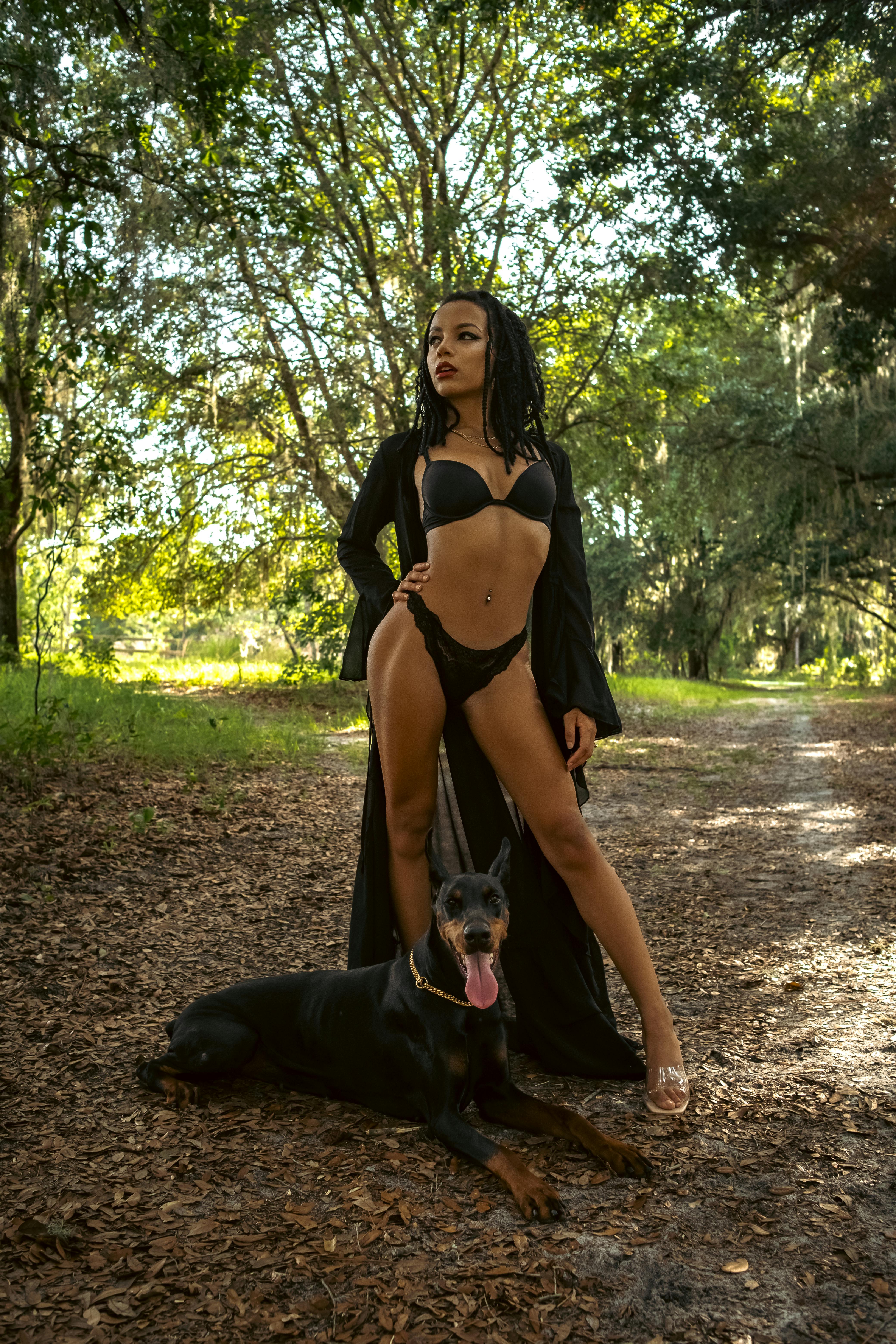 Woman in Underwear Posing with Dog in Forest  Free Stock Photo