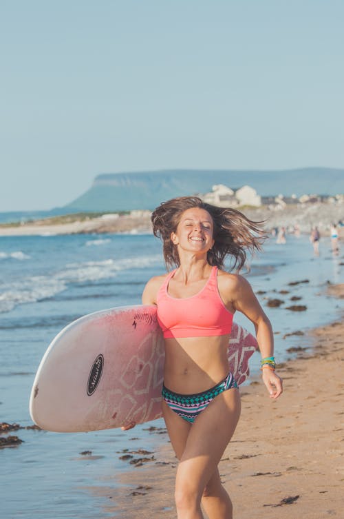 Surfer Running on Beach