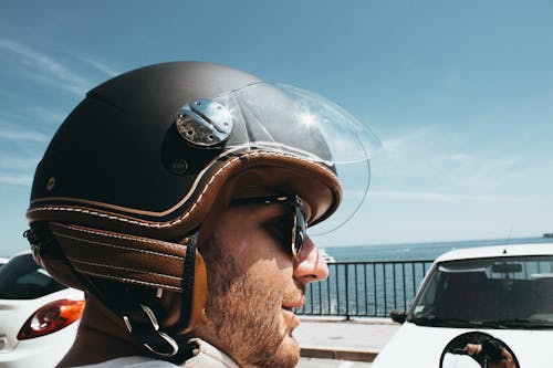 Man Wearing Black-and-brown Half-face Helmet and Black Sunglasses